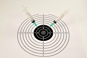 Concept. Grafting. Medical syringes and a target.