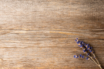 Bunch of dried lavender flowers on the rustic wooden background. Shot from above.