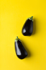 Eggplant or aubergine on yellow background, healthy eating concept © aamulya