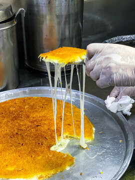 Preparation of Knafeh or Kanafeh, a traditional Middle Eastern dessert