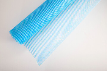 Blue reinforcing construction mesh for wall strengthening on white background, isolate. Close-up