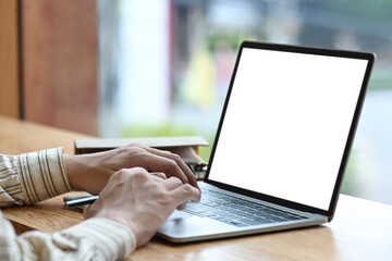 Close up view businessman sitting in bright office and working with computer laptop.