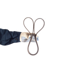 Auto locksmith holding a used timing belt on a white background, isolate. Regulations for replacing belts and rollers of the engine, industrial