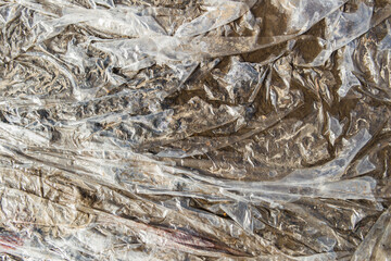 Gray plastic texture of wet cellophane. Abstract background