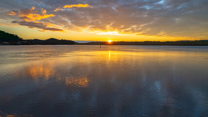 Sunrise waterscape and reflections with clouds