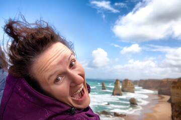 Happiness on face of girl who admires the view of the 12 apostles in Australia