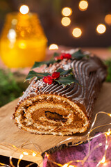 Traditional Christmas cake, chocolate Yule log with festive decorations 