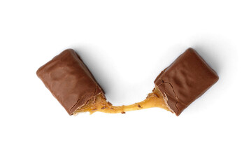 Broken chocolate bar with nougat and caramel isolated on white background.
