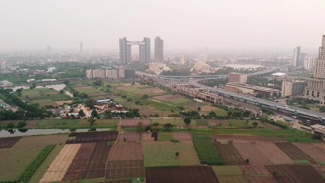 Aerial view of ITC Sonar Royal Bengal, JW Marriott. MAA flyover, Atmosphere and Trump Tower from a nearby farm in summer day. Exclusive aerial view of Kolkata city life. Drone view graded video.