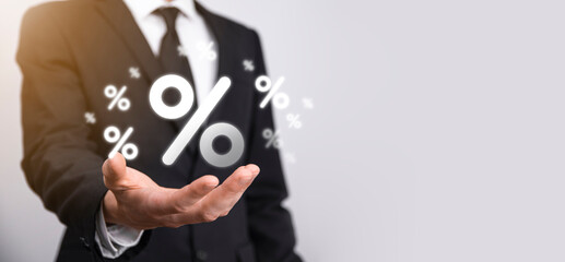 Male hand holding interest rate percent icon on blue background. Interest rate financial and mortgage rates concept.Banner with copy space