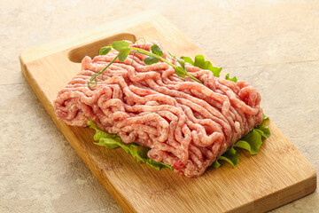 Raw minced pork meat over board