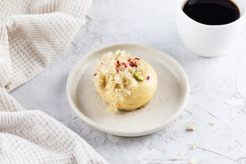 Delicious mousse cake with raspberries and nuts on a plate.