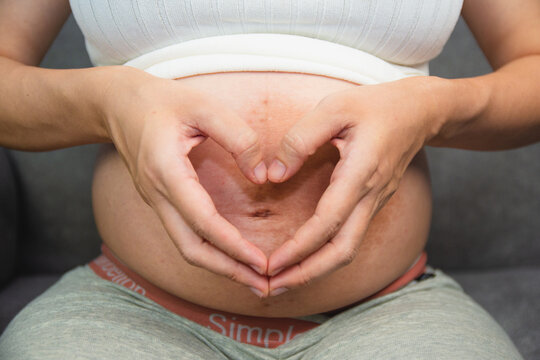 pregnant woman holding her stomach love baby
