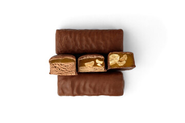 Three types of chocolate sweets with nougat, caramel and nuts.