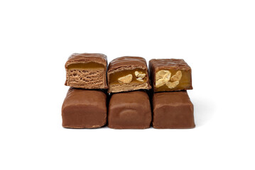 Three types of chocolate sweets with nougat, caramel and nuts.