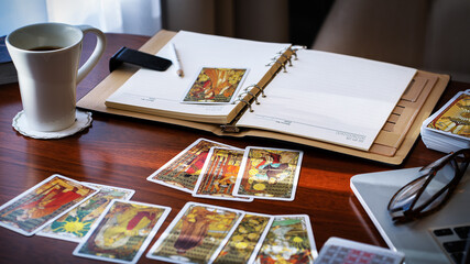 Tarot card reader arranges cards in a card spread. Fortune-telling concept