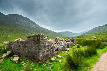 Along the West Highland Way. A ruined farmhouse in the highland moor stands on the edge of the hiking path.