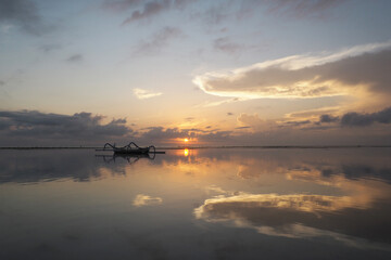 Obraz na płótnie Canvas Beautiful morning, very calm, with reflection of sky on the water. Sanur Beach, Denpasar City, Bali Province, Indonesia