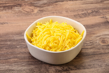 Shredded yellow cheese in the bowl