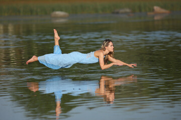 young woman in the water in a dress