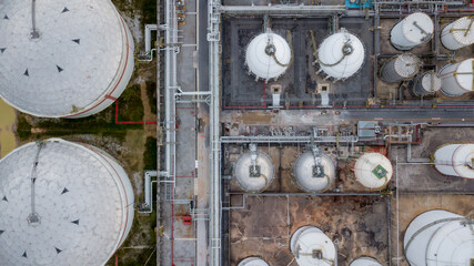 Aerial view storage tank farm at night, Tank farm storage chemical petroleum petrochemical refinery product at oil terminal, Business commercial trade fuel and energy transport by tanker vessel.