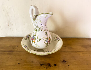 porcelaine washbasin and jug on wood table