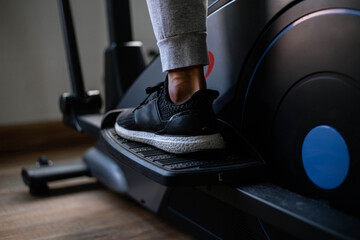 Training gym concept a male teenager doing cardio workout on cycling machine in the gym as his healthy routine