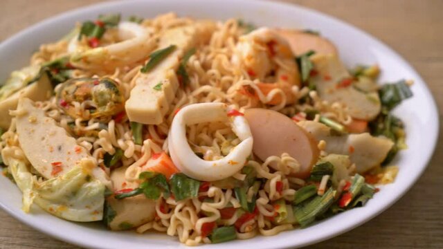 Instant noodle spicy salad with mixed meats - Asian food style