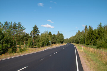new empty asphalt road and blue sky in the forest
