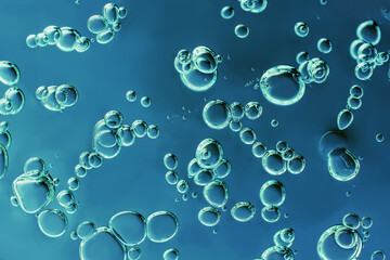 Close up macro Aloe vera gel cosmetic texture blue background with bubbles.