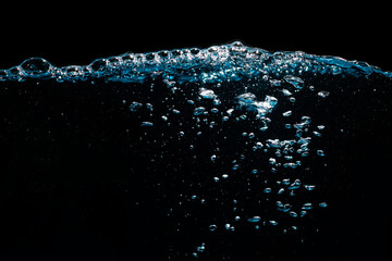 Water Surface with Ripple and Bubbles Float Up on Black Background.	
