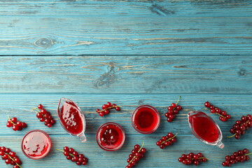 Bowls with cranberry sauce and ingredients on wooden background