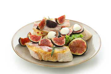 Plate with bruschetta with fig isolated on white background