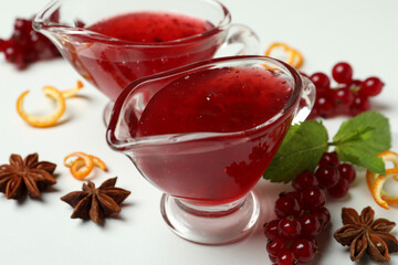 Cranberry sauce and ingredients on white background