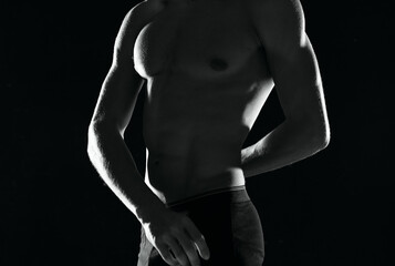 Fototapeta na wymiar a man in black panties with a pumped-up body black and white photo