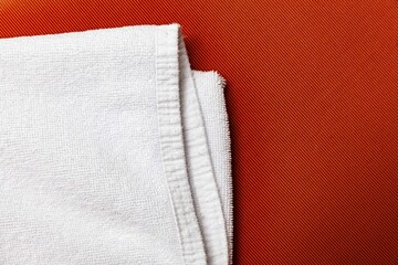 Clean white towels folded on brown wood table