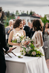 Portrait of two loving female lesbian LGBT brides telling their marriage vows at the wedding...