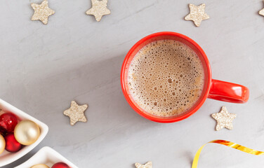 Coffee in a red mug on the New Year's table, top view