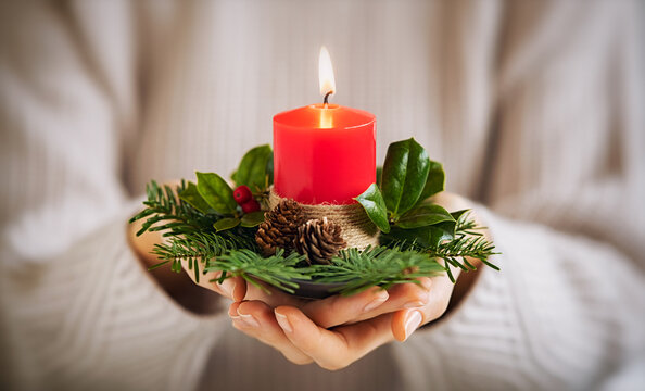 Woman holding christmas candle and fir