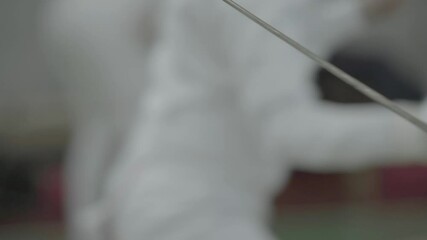 Swordsman with a sword during fencing competitions