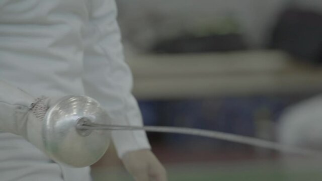 Swordsman with a sword during fencing competitions