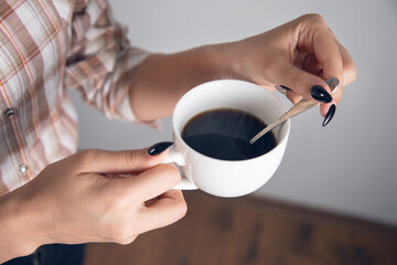 woman holding cup of coffee