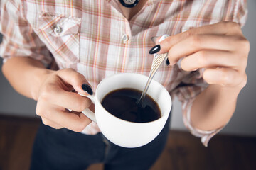 woman holding cup of coffee
