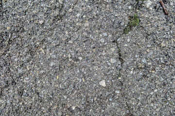 Texture of black old asphalt and pebbles