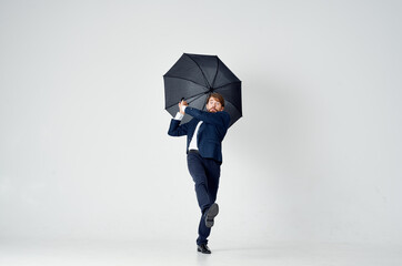 man in suit holding an umbrella in his hands elegant style weather rain