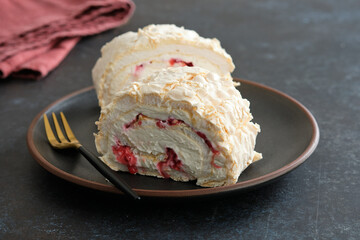 Meringue roll cake with cream, raspberries. Roulade, summer dessert. Confectionery, menu. Close up