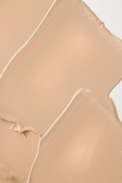 Beige cosmetic texture background, make-up and skincare cosmetics product, cream, lipstick, foundation macro as luxury beauty brand, holiday flatlay design.