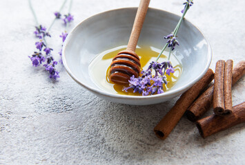 Bowl with honey and fresh lavender flowers