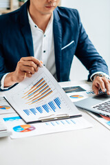 Business man is checking and auditing the business performance with a help from his college....