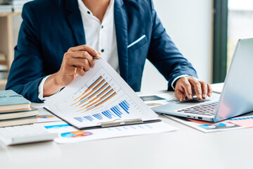 Business man is checking and auditing the business performance with a help from his college. Analyzing the revenue and auditing the budget concept.